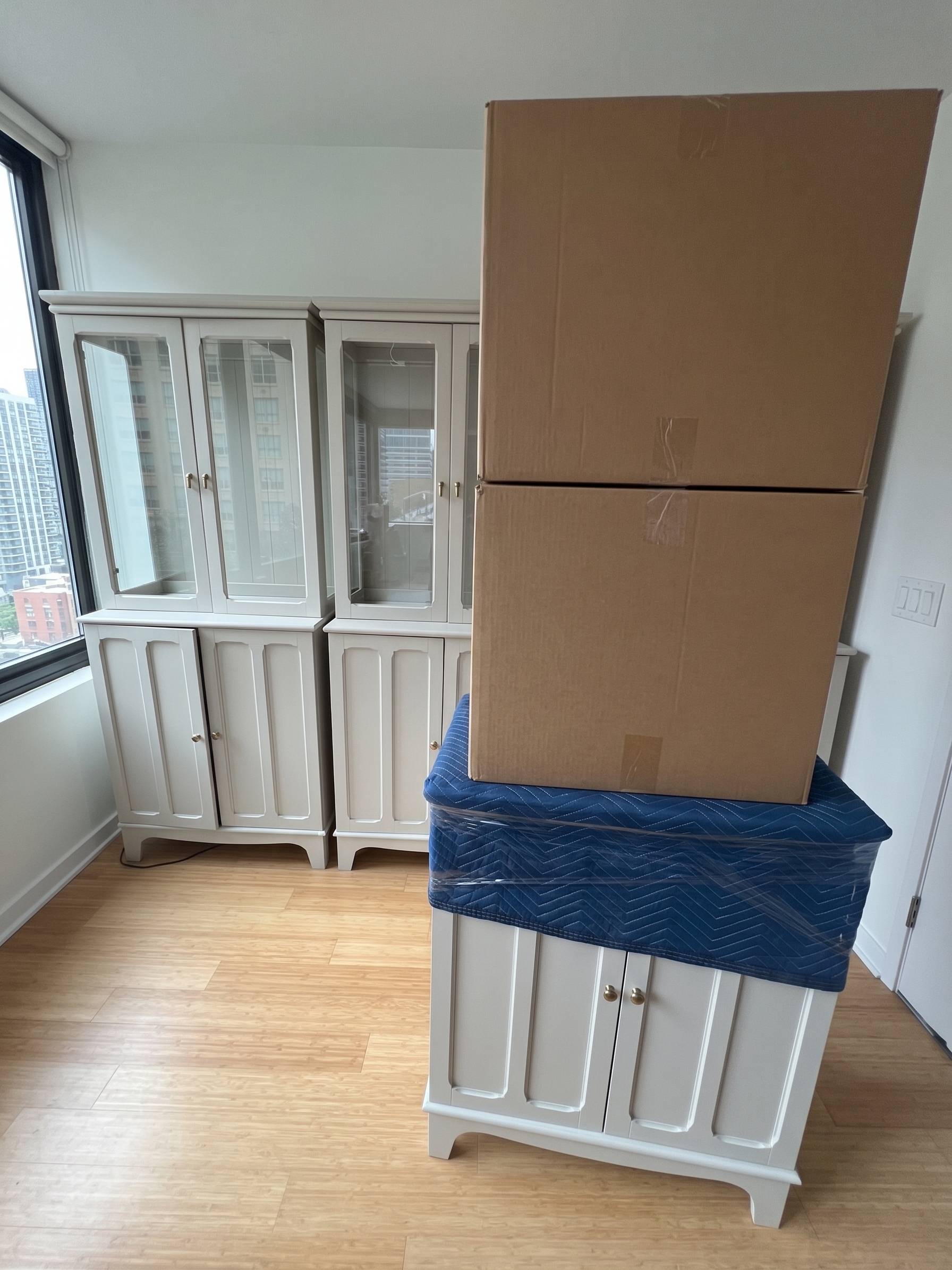Cabinet protected with blankets and cardboard before moving